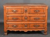 an antique chest of drawers with a wooden top and brass handles