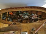 a person holding a wooden boat with many wires in it