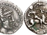 a close up of a coin with a horse and a bird on it
