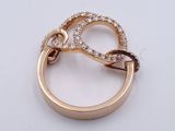 a gold ring with diamonds on it on a white surface