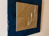 a mirror hanging on the wall next to a wall