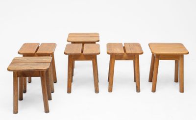 several small wooden stools and tables are arranged in a row