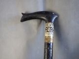 a cane that has a stick on it with a sticker on it