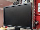 a computer monitor sitting on top of a white desk
