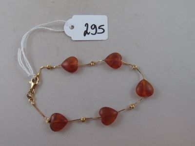 a picture of a bracelet with red beads and a price tag
