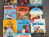 several children ' s books are lined up on a table