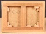 a close up of a wooden frame with a picture in it