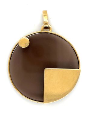 a close up of a brown and gold pendant on a white background