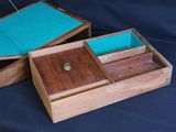 two wooden boxes that are open on a black background
