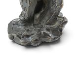 a statue of a bird that is sitting on a rock