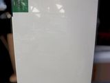 a white box with a green label on it sitting on a table