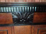 a close up of a wooden cabinet with a decorative design