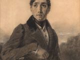 portrait of a man in a suit and tie sitting on a chair