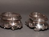 pair of antique silverplated candlestick holders on a black background