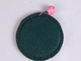 a green coin purse with a pink bead on it