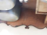 a wooden shelf with a vase on top of it
