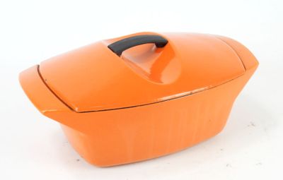 an orange casserole dish with a handle on a white surface