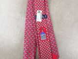 the neck tie is red and white with a blue and red design on it