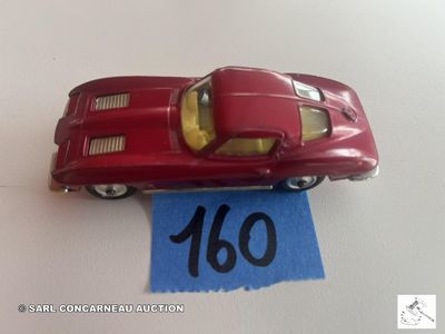 une petite voiture rouge posée sur une feuille de papier bleue
