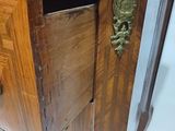 a wooden cabinet with a marble top and a drawer