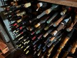many bottles of wine that are sitting in a wine cooler