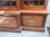 two wooden cabinets with glass doors on each of them