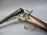 a close up of a gun on a table with a white background