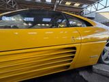 a yellow sports car that is parked in a garage