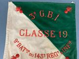 a close up of a green and white flag with red crabs on it