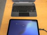 a laptop and a tablet sitting on a table