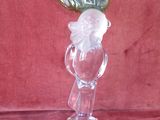 a glass figurine with a leaf on top of it