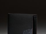 a black leather wallet with a logo on the front