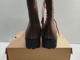 pair of brown boots in a box on a white surface