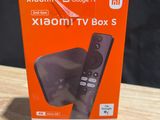 an orange box with a remote control sitting on top of a wooden table