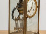 a glass case with a clock inside of it on a table
