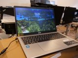 a laptop that is sitting on a table in front of a bunch of monitors