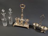 several pieces of silver and glass are arranged on a table