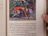 a person holding an open book with a picture on it