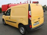 a yellow van that is parked in a parking lot