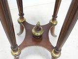 a wooden table with two brass candles on it