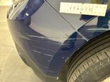 a blue car with a sticker on the side of it