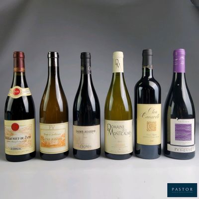 several bottles of wine are lined up in a row on a table