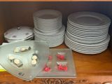 many plates and bowls on a shelf in a cabinet