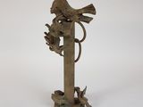 statue of a bird perched on a branch with a bird on it ' s back