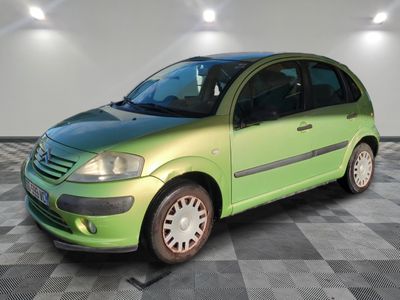 a picture of a green car parked in a garage