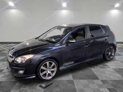 a picture of a black car parked on a checkered floor