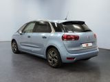 the rear end of a blue citrole parked in a room