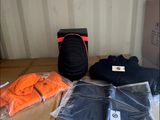 a box with a backpack, a pair of shoes, a pair of pants, and a pair of socks