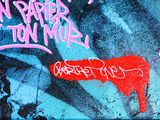 graffiti on the wall of a building with a red heart on it
