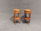 pair of small wooden side tables on a grey background